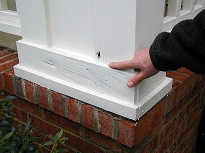 Figure 8. Person pointing to hole and soft spot on wooden porch